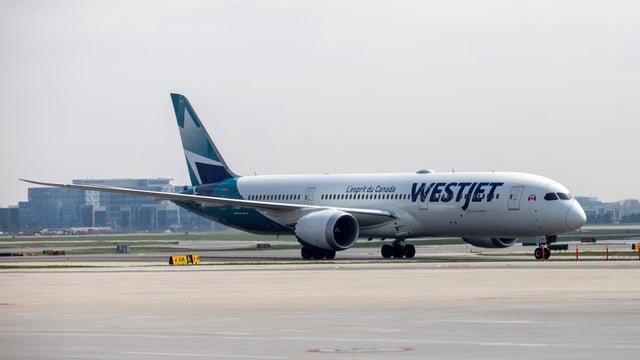 A WestJet Boeing 787-9 Dreamliner airplane taxis along a runway at Toronto Pearson Airport in Mississauga, Ont., on April 28, 2021. WestJet will suspend nine routes between the U.S. and Canada as demand dampens for travel between the two countries.