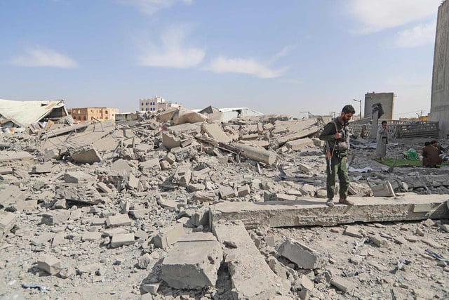 A Houthi fighter surveys the damage following overnight strikes attributed by the Yemeni media to the U.S., in Sanaa, Yemen, on April 27, 2025.