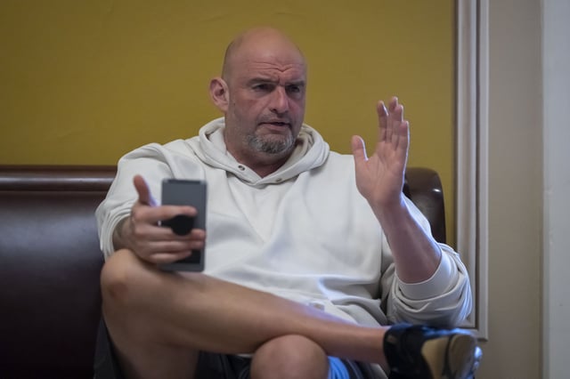 FILE - Sen. John Fetterman, D-Pa., speaks to a reporter near the Senate chamber at the Capitol in Washington, March 14, 2025. (AP Photo/Ben Curtis, File)