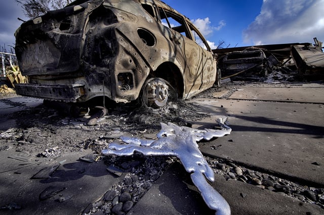 FILE - Melted metal and burned out cars sit destroyed in a driveway of a home burned by the wildfire that spread through the Pacific Palisades neighborhood of Los Angeles on Friday, Jan.17, 2025. (AP Photo/Richard Vogel, File)