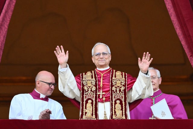 TOPSHOT - Newly elected Pope Leo XIV, Robert Francis Prevost arrives on the main central loggia balcony of the St Peter&#39;s Basilica for the first time, after the cardinals ended the conclave, in The Vatican, on May 8, 2025. Robert Francis Prevost was on Thursday elected the first pope from the United States, the Vatican announced. A moderate who was close to Pope Francis and spent years as a missionary in Peru, he becomes the Catholic Church&#39;s 267th pontiff, taking the papal name Leo XIV.