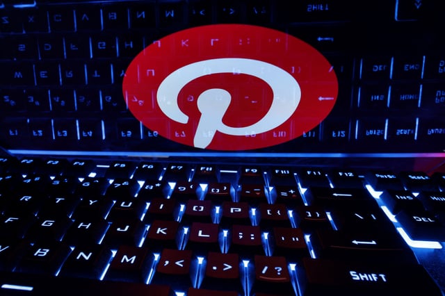 A keyboard is placed in front of a displayed Pinterest logo in this illustration taken February 21, 2023. REUTERS/Dado Ruvic/Illustration/ File Photo