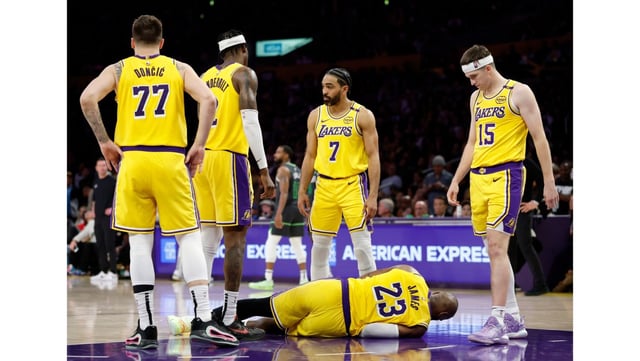 Lakers teammates surround LeBron James after he collided with Minnesota’s Donte DiVincenzo during the fourth quarter of Game 5 of the Western Conference first-round series April 30, 2025, at Crypto.com Arena. (Photo by Harry How/Getty Images)