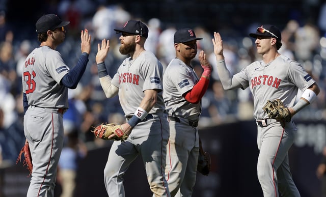 Triston Casas #36, Trevor Story #10, Rafael Devers #11 and Romy Gonzalez #23 of the Boston Red Sox celebrate after defeating the New York Yankees at Yankee Stadium on September 14, 2024 in New York City.