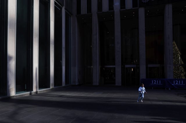 A little girl runs in a shaft of light at the entrance to the News Corp. Building in the Midtown section of New York City, U.S., November 30, 2023. REUTERS/Shannon Stapleton/File Photo