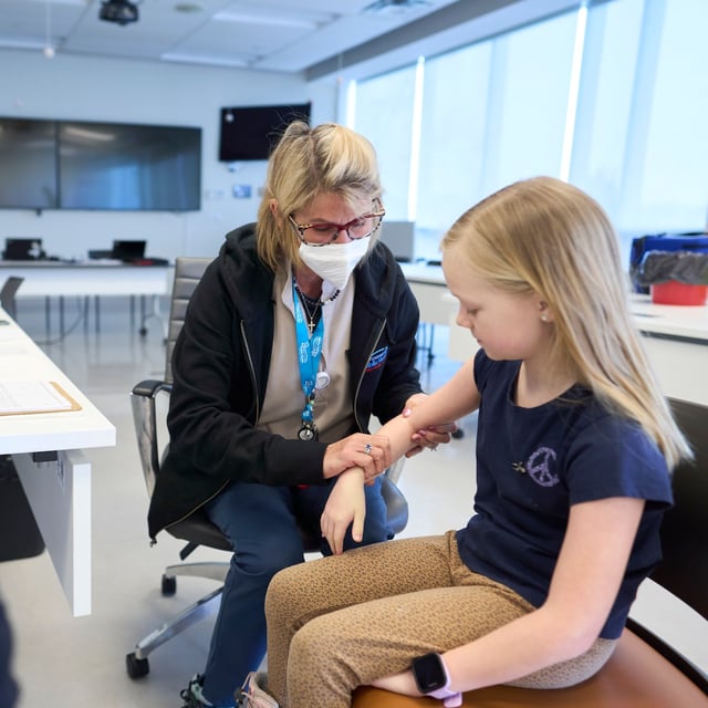 Public health nurse Lauri Bidinot demonstrates how to give a measles shot to a young girl at Southwestern Public Health in St. Thomas, Ont. on Tuesday, March 4, 2025.THE CANADIAN PRESS/ Geoff Robins