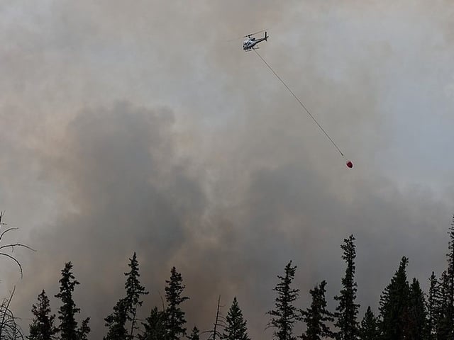 Wildfire crews respond to a fire near Deer Ridge Estates in the County of Grande Prairie on Sunday, May 4, 2025. Around 4:45 p.m. police were observed blocking Highway 40 near Grande Prairie and telling campers at the KOA campground to evacuate due to the wildfire. 