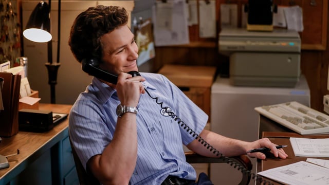 Georgie on the phone at his desk
