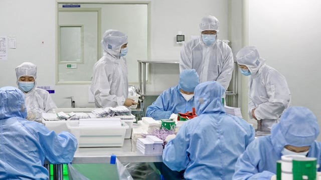 People in PPE kits during the Covid-19 pandemic in 2021.