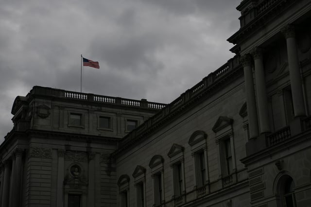 An American flag waves in the wind atop the Library of Congress on Capitol Hill in Washington, U.S., November 22, 2019. REUTERS/Loren Elliott/File Photo