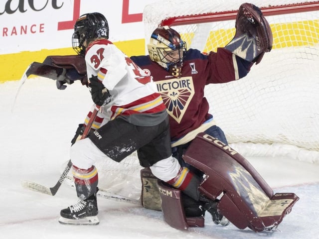 Ottawa Charge's Rebecca Leslie (37) gets tangled with Montreal Victoire goaltender Ann-Renee Desbiens (35) during second period PWHL playoff hockey action in Laval, Que., on May 8, 2025. 