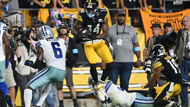 Oct 6, 2024; Pittsburgh, Pennsylvania, USA; Pittsburgh Steelers wide receiver George Pickens (14) makes a catch in front of Dallas Cowboys safety Donovan Wilson (6) during the fourth quarter at Acrisure Stadium. Mandatory Credit: Barry Reeger-Imagn Images