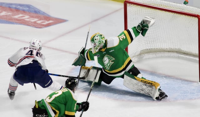 London, Ont. - Austin Elliott of the London Knights stretches out toshield his net from Beckett Sennecke of the Oshawa Generals in Game 1 of the OHL Championship Series on May 8, 2025 at Canada Life Place.