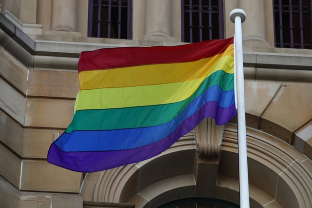 SYDNEY, AUSTRALIA - FEBRUARY 19: The Rainbow flag is raised at Town Hall during a flag raising ceremony at Sydney Town Hall on February 19, 2021 in Sydney, Australia. (Photo by Don Arnold/WireImage)