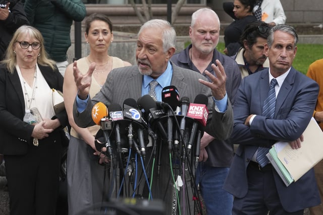 Attorney Mark Geragos, center, representing Erik and Lyle Menendez, who were sentenced in 1996 to life in prison without the possibility of parole for fatally shooting their parents, speaks to the media outside of court after a resentencing hearing in their case, Thursday, April 17, 2025, in Los Angeles. (AP Photo/Damian Dovarganes)