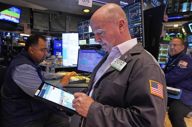 Trader Patrick Casey, center, works on the floor of the New York Stock Exchange, Thursday, May 8, 2025. (AP Photo/Richard Drew)