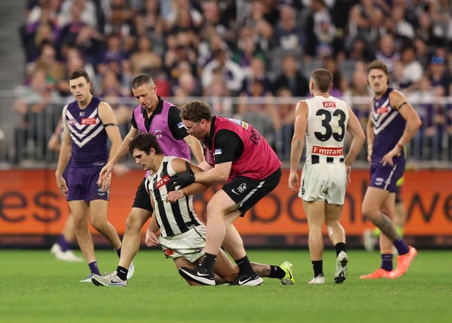 Lachie Schultz attempts to get up after his hit.