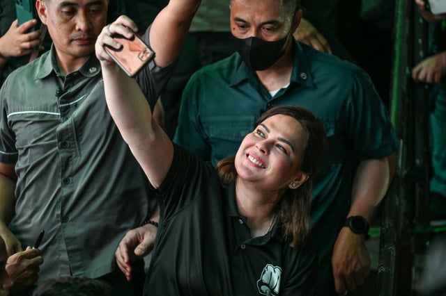 Philippines Vice President Sara Duterte snaps a selfie at a Manila campaign rally