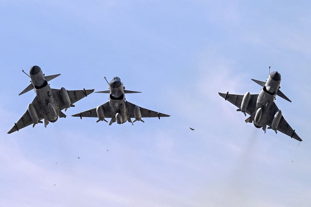 Pakistan Air Force J-10 fighter jets fly past over the President's House during the national day parade in Islamabad on March 23, 2025.