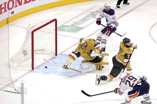 Edmonton Oilers center Leon Draisaitl (29) scores against Vegas Golden Knights goaltender Adin Hill (33) in overtime of Game 2 in an NHL hockey second-round playoff series Thursday, May 8, 2025, in Las Vegas.
