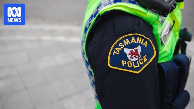 Police officers in uniform patrolling a street.