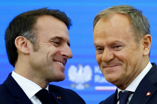 French President Emmanuel Macron reacts next to Polish Prime Minister Donald Tusk, at the Chancellery of the Prime Minister, in Warsaw, Poland, December 12, 2024. REUTERS/Kacper Pempel/File Photo
