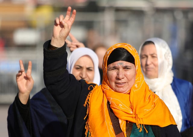 People flash V-signs as they gather to watch a televised press conference of the pro-Kurdish Peoples' Equality and Democracy Party (DEM Party), in Diyarbakir, Turkey, February 27, 2025. REUTERS/Sertac Kayar