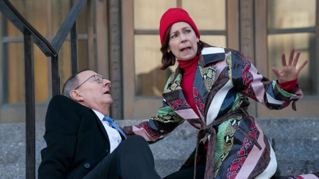 Elsbeth helps a collapsed man on a set of stairs