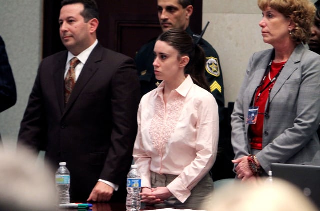Casey Anthony, and her attorneys Jose Baez, left, and Dorothy Clay Sims, right, stand before the jury presents a verdict in her murder trial at the Orange County Courthouse on July 5, 2011, in Orlando, Florida.