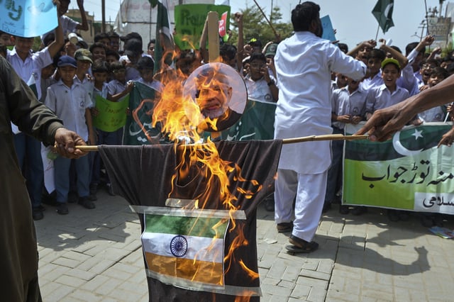 Supporters of Jamaat-e-Islami burn an effigy of Indian Prime Minister Narendra Modi with Indian flag during a demonstration to condemn Indian strikes in Pakistan and to show their support for Pakistan military, in Karachi, Pakistan, Friday, May 9, 2025.