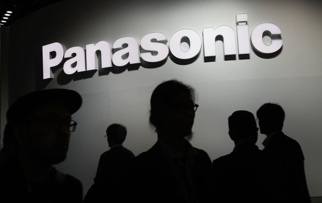 FILE - People walk by the Panasonic booth during CES International in Las Vegas on Jan. 9, 2018. (AP Photo/John Locher, File)
