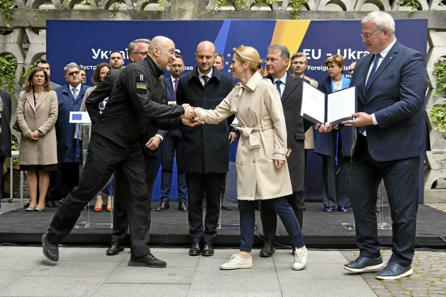 Le Premier ministre ukrainien Denys Chmyhal et la Haute Représentante de l’Union européenne pour les affaires étrangères et la politique de sécurité, Kaja Kallas, se serrent la main après avoir signé un accord portant sur le transfert à l’Ukraine d’une tranche des revenus issus des avoirs russes gelés, lors de la réunion des ministres des Affaires étrangères UA-UE à Lviv, en Ukraine, le vendredi 9 mai 2025.
