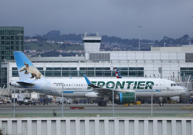 A Frontier Airlines plane taxis at San Francisco International Airport on April 15, 2025 in San Francisco, California.