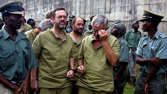 Mann, left, at a maximum security prison in Harare, Zimbabwe, after his arrest in 2004