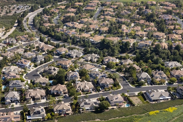 In an aerial view, single family homes neighbor open space on April 19, 2025 in Thousand Oaks, California.