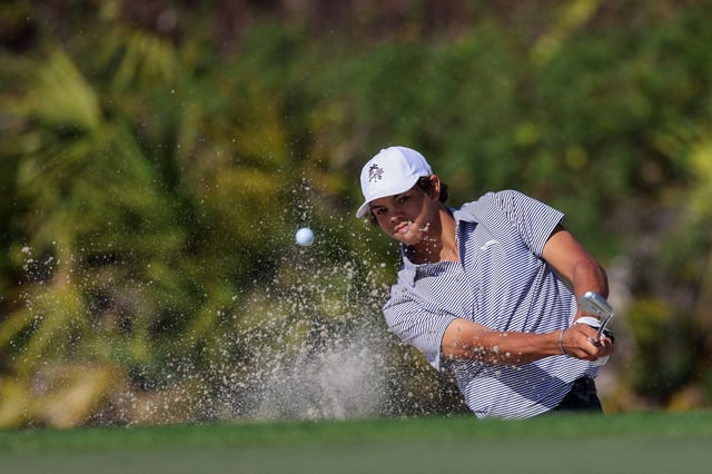 Dec 21, 2024; Orlando, Florida, [USA]; Charlie Woods chips out of the fourth hole bunker during the PNC Championship at The Ritz-Carlton Golf Club. Mandatory Credit: Nathan Ray Seebeck-Imagn Images/File Photo