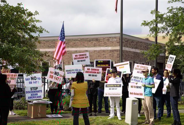 People protest against SB 147, a bill that would restrict land ownership in Texas, outside Sen. Lois Kolkhorst’s office Thursday, April 27, 2023, in Katy. Kolkhorst is the author of the bill. 
