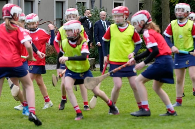 Joe Biden and Ireland’s Taoiseach Leo Varadkar watch as girls play hurling during a youth Gaelic sports demonstration at Farmleigh House on April 13, 2023, in Dublin, Ireland. (AP Photo/Patrick Semansky)