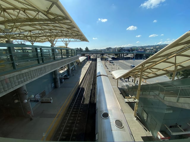 A train pulls in to unload a few passengers in the suburb of Millbrae, at a station where the region's two major rail systems meet in San Francisco, U.S., March 20, 2020. REUTERS/Stephen Nellis/File Photo