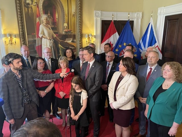  John Hogan, the province’s 15th premier, speaks to media in a scrum after being sworn in as premier. His cabinet, which he announced on May 9, stands behind him.