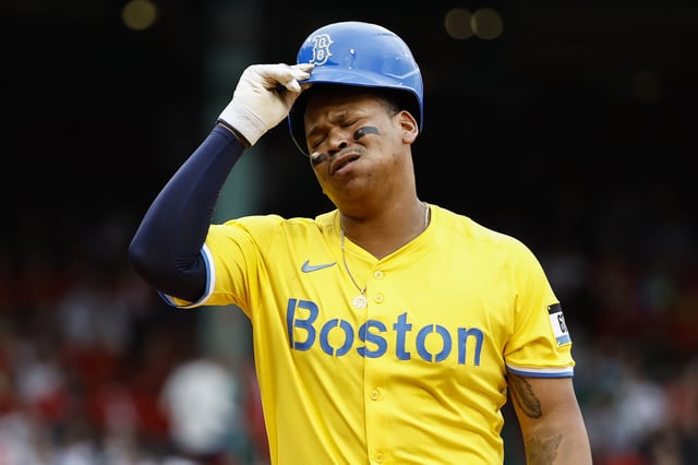 BOSTON, MA - MAY 3: Rafael Devers #11 of the Boston Red Sox takes off his helmet as he heads for the dugout after flying out to end the fifth inning against the Minnesota Twins at Fenway Park on May 3, 2025 in Boston, Massachusetts. (Photo By Winslow Townson/Getty Images)