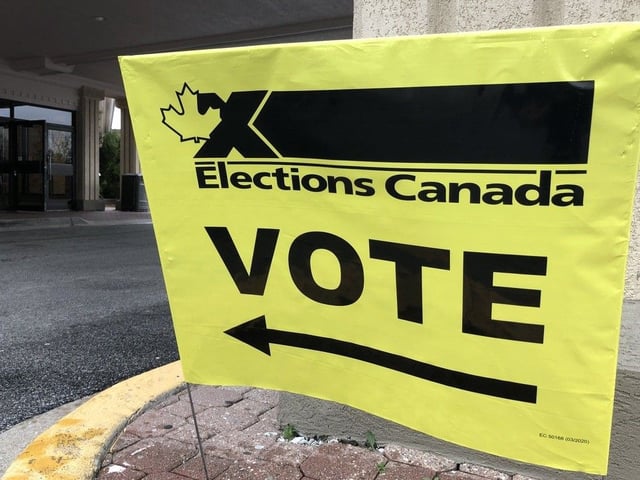 Elections Canada signage points the way for voters at the federal election advance poll for the Windsor West riding at the Caboto Club on April 19, 2025.