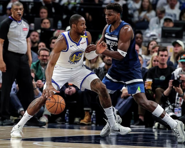 Golden State Warriors forward Jonathan Kuminga drives to the basket against Minnesota Timberwolves guard Anthony Edwards during the first half of Game 2 of their second-round playoff series Thursday, May 8, 2025, in Minneapolis.