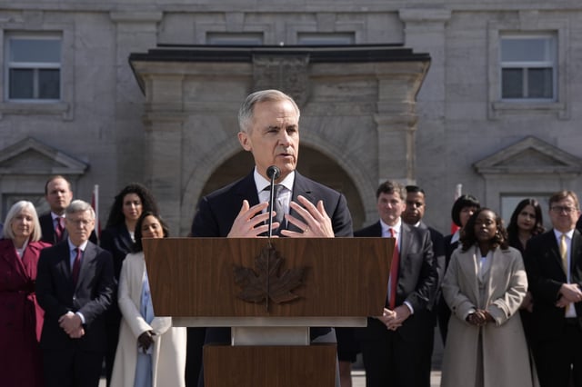Prime Minister Mark Carney holds a press conference as members of his cabinet look on following a swearing in ceremony at Rideau Hall in Ottawa on Friday, March 14, 2025. THE CANADIAN PRESS/Adrian Wyld