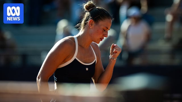 Marta Kostyuk clenches her fist during a tennis match.