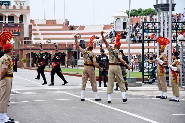 Pakistan Rangers soldiers, in black, face Indian Border Security Force soldiers at a daily closing ceremony on the Indian side of the Attari-Wagah border, on Aug. 9, 2019.