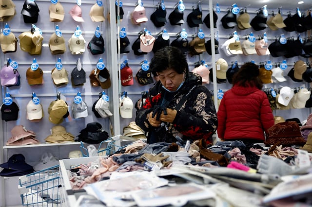 Customers shop for gloves at the Wankelai store in Beijing, China February 27, 2025. REUTERS/Tingshu Wang/File Photo