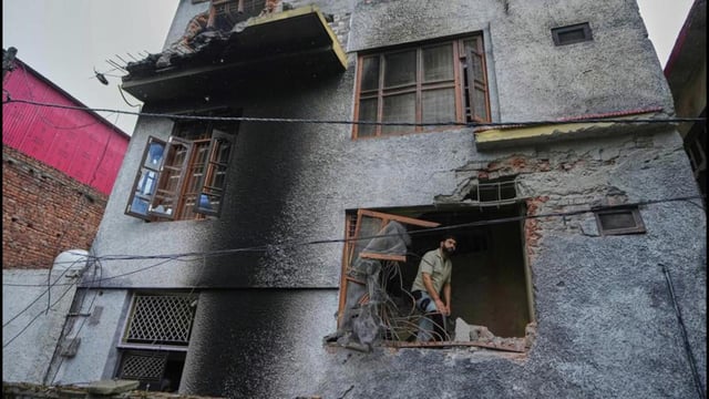 A resident inspects his house damaged by Pakistani artillery shelling in Poonch, along the Line of Control, Indian controlled Kashmir on Thursday. (AP)