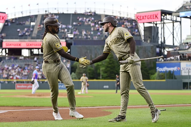 DENVER, CO – MAY 09: Fernando Tatis Jr. #23 of the San Diego Padres high-fives Jackson Merrill #3 after scoring a run in the top of the first inning during the game between the San Diego Padres and the Colorado Rockies at Coors Field on Friday, May 9, 2025 in Denver, Colorado. (Photo by Dustin Bradford/MLB Photos via Getty Images)