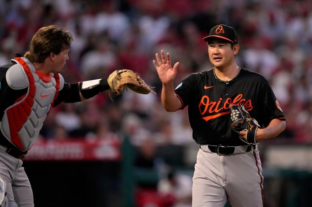 Baltimore Orioles catcher Adley Rutschman, left, and starting pitcher Tomoyuki Sugano congratulate each other after closing out the fourth inning of a baseball game against the Los Angeles Angels, Friday, May 9, 2025, in Anaheim, Calif. (AP Photo/Mark J. Terrill)